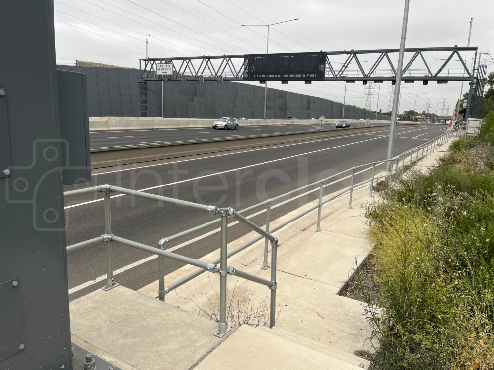Interclamp key clamp barrier installed next to a highway allowing maintenance staff safe to work safely
